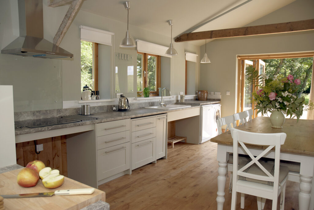 Kitchen and dining area with accessible units and level worktops in the barn accommodation
